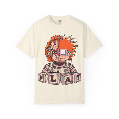 Beige t-shirt with a graphic design of a character with red hair and 'PLAY' blocks on a white background
