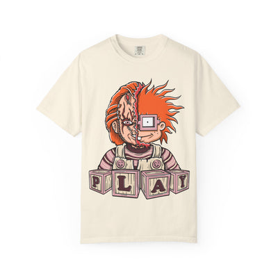 Beige t-shirt with a graphic design of a character with red hair and 'PLAY' blocks on a white background