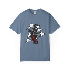 Blue t-shirt with a graphic of a skeleton on a skateboard against a white background