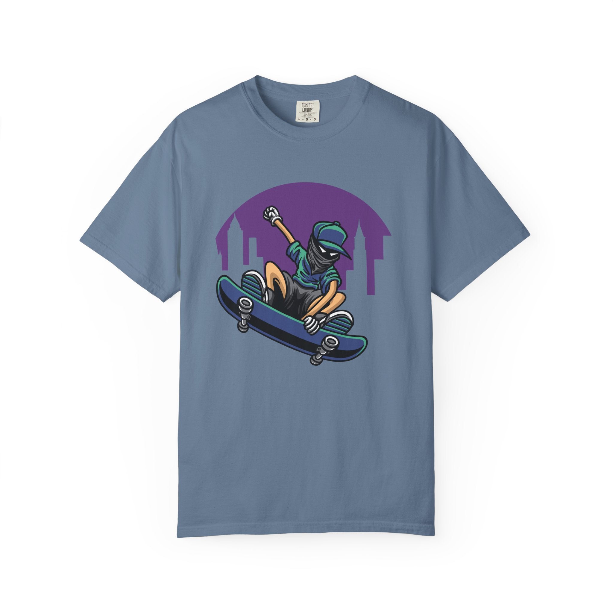 Blue t-shirt with a graphic of a person on a skateboard and city skyline.